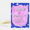 A folded greeting card with a pink shield-shaped design on a blue starry background, featuring the text "100% of DREAMS COME TRUE".