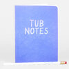 A blue notebook with rounded corners and the words "TUB NOTES" printed on the cover, shown with a white pencil labeled "TUB NOTES" and a pink eraser tip.