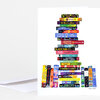 A folded greeting card featuring a colorful illustration of a stack of fantasy book spines forming a tree-like shape, with the artist signature “Jane Mount” at the bottom right.