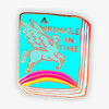 An enamel-style pin shaped like a book cover with the text "A WRINKLE IN TIME," featuring a winged centaur-like figure and a rainbow across the bottom.