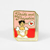 A gold-outlined enamel pin shaped like a pink book cover with the words "Pride and Prejudice," an illustration of a woman in a white dress, and a small heart in a speech bubble.