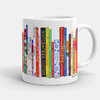 A white ceramic mug with a wraparound print of colorful book spines featuring Christmas and winter-themed titles and designs, with a handle on the right.