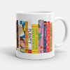 A white ceramic mug printed with a row of colorful cookbook spines, including visible titles such as “PLENTY,” “HOW TO COOK EVERYTHING,” and “HOW TO COOK,” wrapping around the side.