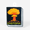 A die-cut sticker shaped like a book cover shows a stylized nuclear explosion above a city skyline with the word "DYSTOPIA" in yellow at the bottom.