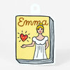 A die-cut sticker shaped like a book cover with the word "Emma" at the top and an illustration of a blonde woman in a white dress holding a glittery red heart.