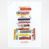 A white tea towel printed with a stack of illustrated cookbook spines forming a bookshelf, including visible titles such as "Cook As You Are," "How to Cook Everything," "Home Is Where the Eggs Are," "Cook This Book," "barefoot contessa at home," "nothing fancy," "Six Seasons," "Dinner," "PLENTY," and "New York Times Cookbook," with "IDEAL BOOKSHELF" printed at the bottom and "Jane Mount" near the lower right.