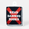 A sticker shaped like a small book with a tab, showing a black cover graphic with a large red X and the words "READ BANNED BOOKS" in white.