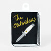 A die-cut sticker shaped like a book cover with the words "The Outsiders" and a knife illustration on a black background.