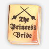 A rectangular enamel pin with rounded corners showing crossed swords above the black text "The Princess Bride".