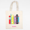 An unbleached canvas tote bag with two handles and a printed row of colorful book spines featuring readable titles including "My Favorite Book," "Book That Makes Me Laugh Out Loud," "Book I Love the Most," "Super Fantastic Book," "Best Book I Ever Read," "UNFORGETTABLE BOOK," and "Book That Gives Me Happy Tears," with "IDEAL BOOKSHELF" printed below.