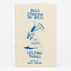 A small zine with a cream cover showing blue hand-drawn text reading "BUGS STANDING ON ROCKS HOLDING THINGS" and an illustration of a bug standing on a rock while holding a sandwich, with "PAINTINGS BY JACKIE THOMSON" at the bottom.