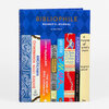 A hardcover journal titled "BIBLIOPHILE READER'S JOURNAL" with a blue patterned cover illustrated as a row of colorful book spines featuring classic titles and authors.