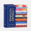 A blue hardcover-style notepad shaped like a book with gold text reading "LITERARY NOTEPAD" and "BIBLIOPHILE," plus a stack of colorful book spines with visible titles on the front.