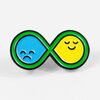 An enamel pin shaped like a green-outlined infinity symbol with a blue sad face on the left loop and a yellow smiling face on the right loop.