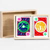 A light wooden box set with two upright printed cards showing a blue-and-green dragon on one card and a yellow tiger on the other, each with red decorative borders and small floral icons.