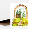 A folded greeting card with a watercolor illustration of a house, trees, flowers, and a rainbow, with the text "I LOVE GETTING OLDER WITH YOU." at the top.