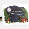A folded greeting card with a hand-lettered message that reads “wishing you a future filled with happiness, joy, and wonder” over a dark night scene with a moon, stars, fern fronds, mushrooms, rocks, and a small frog.