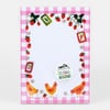 A small notepad with a pink gingham border, strawberry and flower illustrations around the edge, three chickens along the bottom, and a round label reading "LITTLE TRUTHS STUDIO 50 PAGE NOTEPAD".