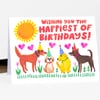 A folded birthday card featuring the text "WISHING YOU THE HAPPIEST OF BIRTHDAYS!" above a bright sun, pink hearts, and four party-hat-wearing dogs.