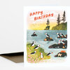 A folded greeting card with the words "HAPPY BIRTHDAY" and an illustrated scene of puffins on small rocky islands in the water.
