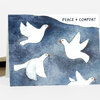 A greeting card featuring four white doves on a blue watercolor background with the text "PEACE + COMFORT" at the top.