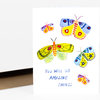 A folded greeting card shows five colorful illustrated butterflies and the handwritten-style text "YOU WILL DO AMAZING THINGS" on the front.