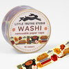 A roll of washi tape labeled "LITTLE TRUTHS STUDIO" and "WASHI removable paper tape" with a fall-themed pattern of apples, pie, leaves, books, and a pot, showing "10 meters" on the label.