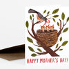 A greeting card shows a bird carrying a worm above three baby birds in a nest on a tree branch with the text "HAPPY MOTHER'S DAY!" at the bottom.