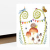 A folded greeting card with a watercolor illustration of a bug-themed birthday scene, featuring a party-hatted blue insect, butterfly, ladybug, snail, mushrooms, and colorful pennant bunting.