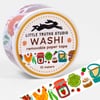 A roll of washi tape with a circular label that reads "LITTLE TRUTHS STUDIO," "WASHI," "removable paper tape," and "10 meters," decorated with small colorful farmer's market-themed illustrations.