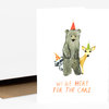 A folded greeting card shows three illustrated animals wearing party hats above the text "WE'RE HERE FOR THE CAKE".