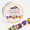 A roll of washi tape labeled “LITTLE TRUTHS STUDIO WASHI removable paper tape 10 meters” with a colorful 80s-themed pattern of retro electronics, including a TV, cassette tape, record player, phone, and typewriter.
