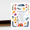 A folded greeting card with watercolor-style illustrated plants, flowers, a cloud, sun, moon, stars, and a rainbow surrounding the handwritten text, "I'm amazed by you. Every time I'm convinced the world is coming apart at the seams, there you are with your needle and thread."