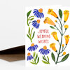 A folded greeting card with watercolor-style yellow and purple flowers and green leaves, with the text "JOYFUL WEDDING WISHES" on the front.