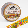 A roll of washi tape labeled "LITTLE TRUTHS STUDIO WASHI removable paper tape 10 meters" with a floral and butterfly pattern visible on the tape.