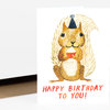 A folded birthday card featuring an illustrated squirrel wearing a party hat and holding a cupcake, with the text "HAPPY BIRTHDAY TO YOU!" on the front.