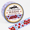 A roll of washi tape labeled "LITTLE TRUTHS STUDIO WASHI removable paper tape 10 meters" with a blue gingham pattern and red tomato vines printed on it.