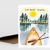 A folded sympathy card shows a watercolor canoe on a lake with reflected pine trees and a yellow sun, with the text "With heartfelt sympathy" at the top.