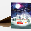 A folded greeting card with a watercolor-style illustration of a red camper van, campfire, string flags, mountains, and a moonlit sky, with the text "Campfire stories, shooting stars, toasted marshmallow wishes."