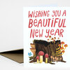 A folded greeting card with the text "WISHING YOU A BEAUTIFUL NEW YEAR" in red lettering and an illustration of mushrooms and a tree stump on the front.