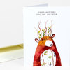 A folded greeting card with the text "HAPPY BIRTHDAY! LONG MAY YOU REIGN." and a watercolor-style bear illustration with leaves and branches growing from its head.