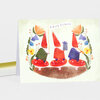 A folded greeting card with three illustrated gnomes on red mushrooms and the text "HAPPY BIRTHDAY" across the top.