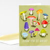 A folded greeting card with illustrated colorful mushrooms and the text "THANK YOU SO MUSH!" on the front.