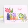 A folded greeting card with the word "yay!" in pink above a colorful illustration of potted flowers, leafy plants, a cat peeking from behind a plant, and small bunting flags.