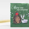 A holiday notecard with the text "Missing you this Christmas" above an illustration of a bear wearing a red face covering beside a rabbit wearing a green face covering, with small white snow dots around them.