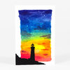 A postcard-sized print of a black lighthouse silhouette against a rainbow watercolor sky with scattered cloud shapes.