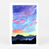 A postcard-sized art print showing a colorful watercolor landscape with layered blue and purple sky, pink clouds, and a dark silhouetted mountain or treeline along the bottom.