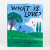 A hardcover book with a blue illustrated cover titled "WHAT IS LOVE?" and text reading "by Mac Barnett" and "illustrated by Carson Ellis."