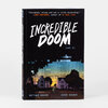 A softcover book titled "INCREDIBLE DOOM [vol 1]" with the authors' names "MATTHEW BOGART" and "JESSE HOLDEN" on the cover.