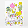 A colorful art print with illustrated flowers, tall plants, small figures, and elephants, featuring the words “STAY GOLDEN” in large yellow letters at the bottom.